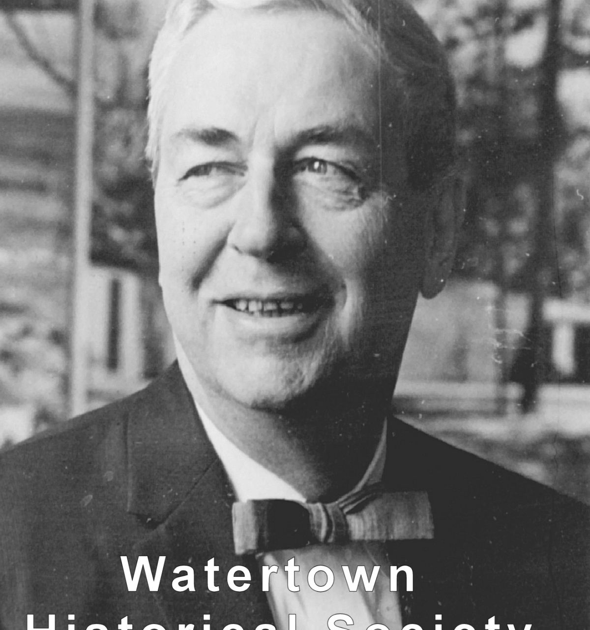 Optima Lakeview® Apartments in Chicago, IL Black and white photo of Modernist Master George Frederick Keck in a bow tie, smiling, with "Watertown Historical Society" text.