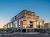 Optima Lakeview® Apartments in Chicago, IL Modern multi-story building with common features of the Optima Portfolio, large windows, brick accents, and lively street-level shops.
