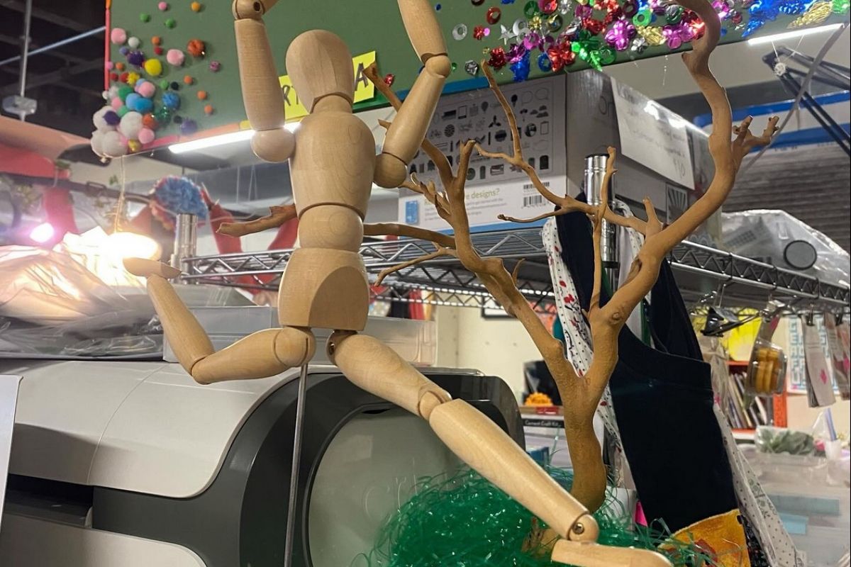 Optima Lakeview® Apartments in Chicago, IL A wooden mannequin poses by a fake tree and craft supplies at The WasteShed, Chicago’s creative reuse art space.