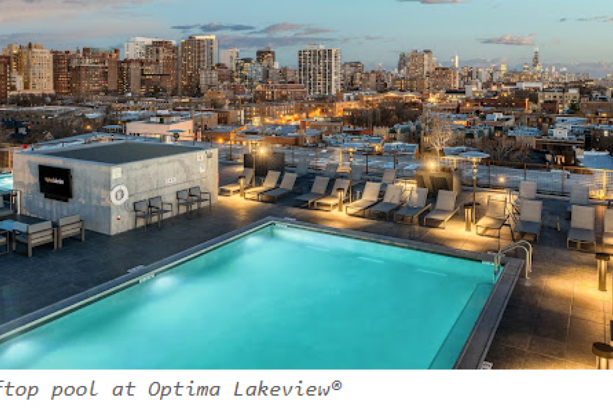 Optima Lakeview® Apartments in Chicago, IL Rooftop pool with lounge chairs overlooking a city skyline at sunset—perfect for swimming for adults or relaxing after a lesson.