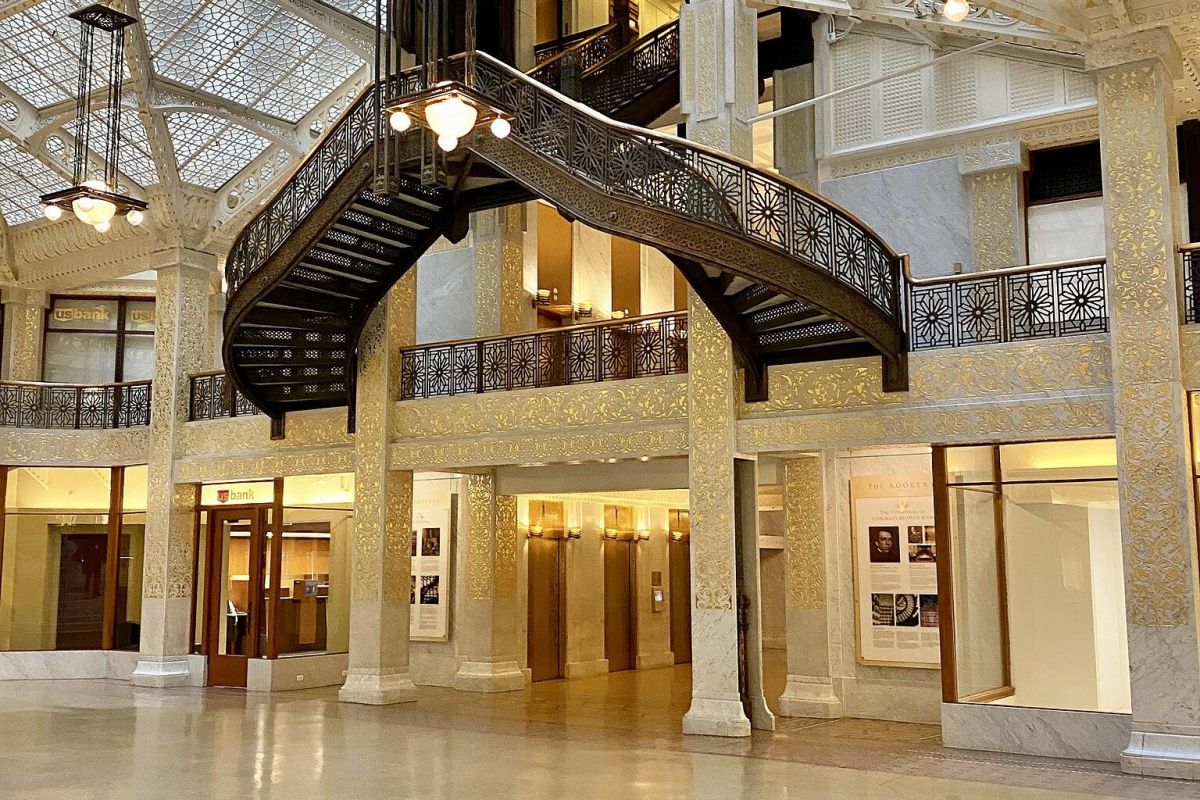 Optima Lakeview® Apartments in Chicago, IL Ornate iron staircase and glass ceiling in a spacious, historic interior—perfect for discovering Chicago's architectural gems.