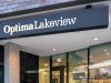 Optima Lakeview® Apartments in Chicago, IL Entrance of a modern building with “Optima Lakeview” above glass doors—perfect for Yoga or Pilates enthusiasts seeking luxury living.
