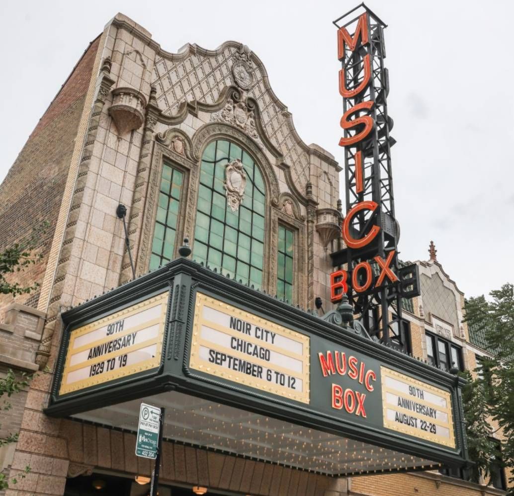 Optima Lakeview® Apartments in Chicago, IL Historic Music Box Theatre with marquee signs for “NOIR CITY CHICAGO” and “90th Anniversary” celebrations.