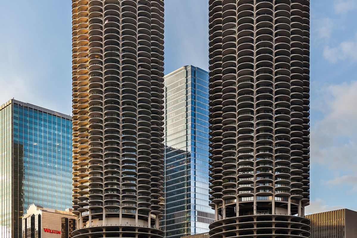 Optima Lakeview® Apartments in Chicago, IL Two tall, cylindrical towers with scalloped balconies rise among Chicago's modern skyscrapers in a striking cityscape.