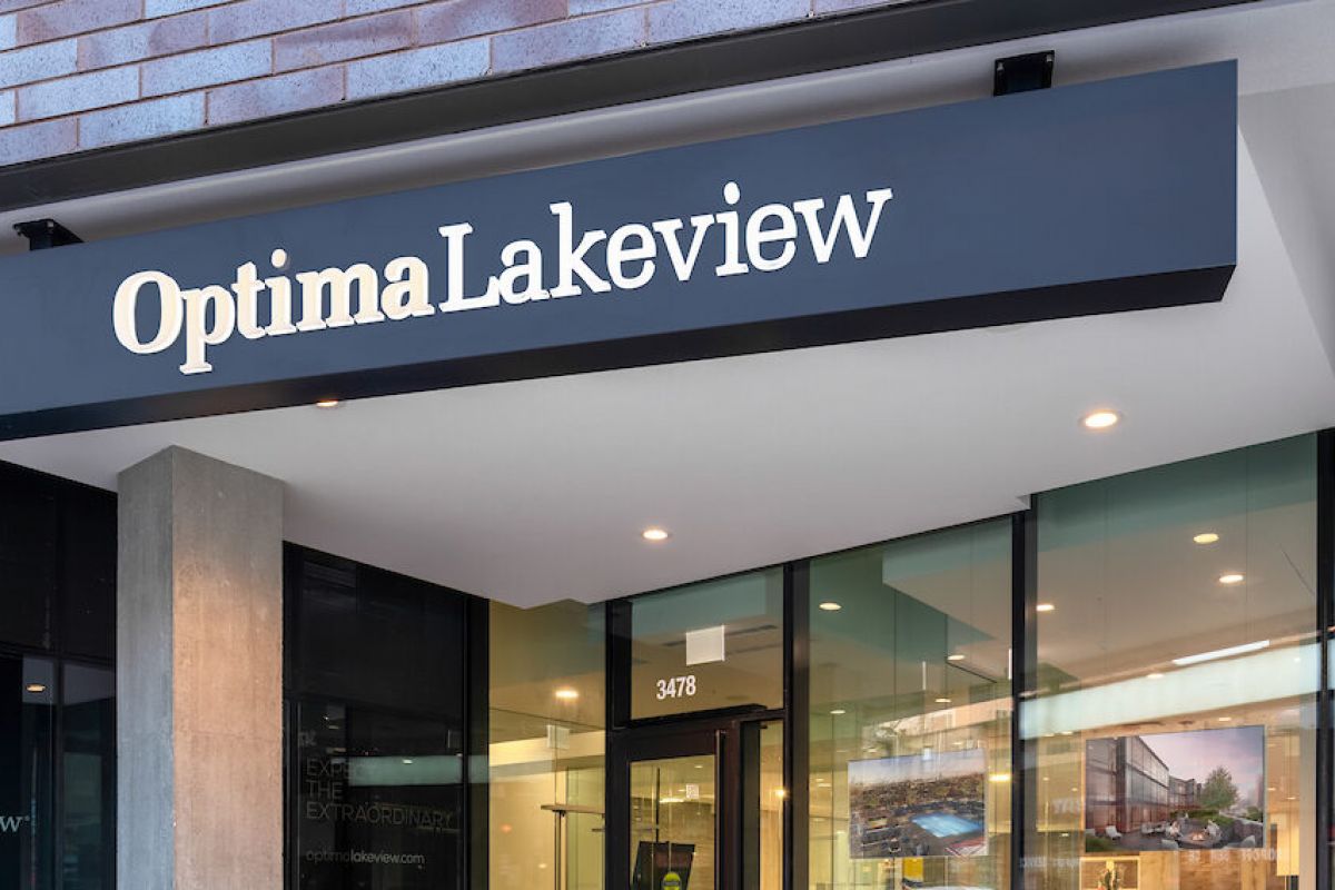 Optima Lakeview® Apartments in Chicago, IL Entrance of a modern building with “Optima Lakeview” above glass doors—perfect for Yoga or Pilates enthusiasts seeking luxury living.
