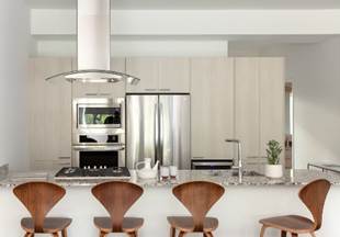 Optima Lakeview® Apartments in Chicago, IL Modern kitchen for luxury living with light wood cabinets, stainless steel appliances, and four curved wooden stools at a granite island.